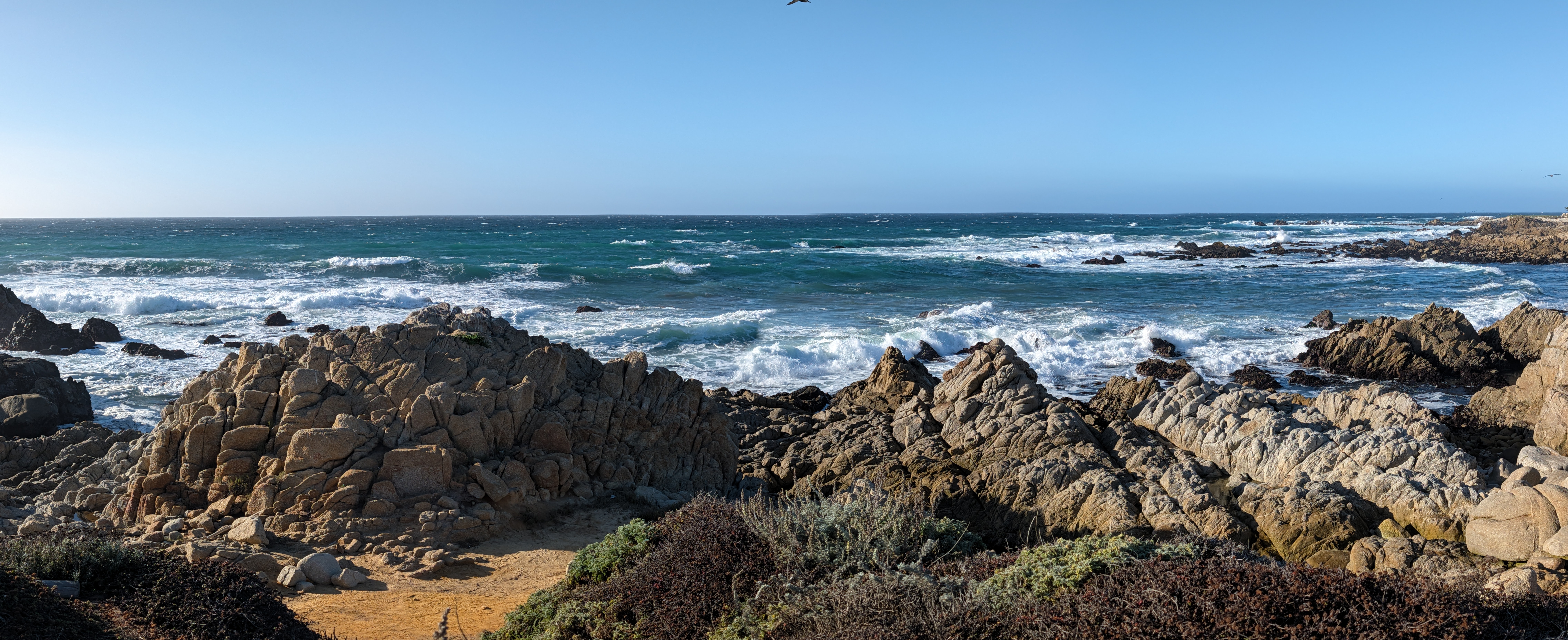 Waves breaking against the rocky shoreline on the Monterey Peninsula.
